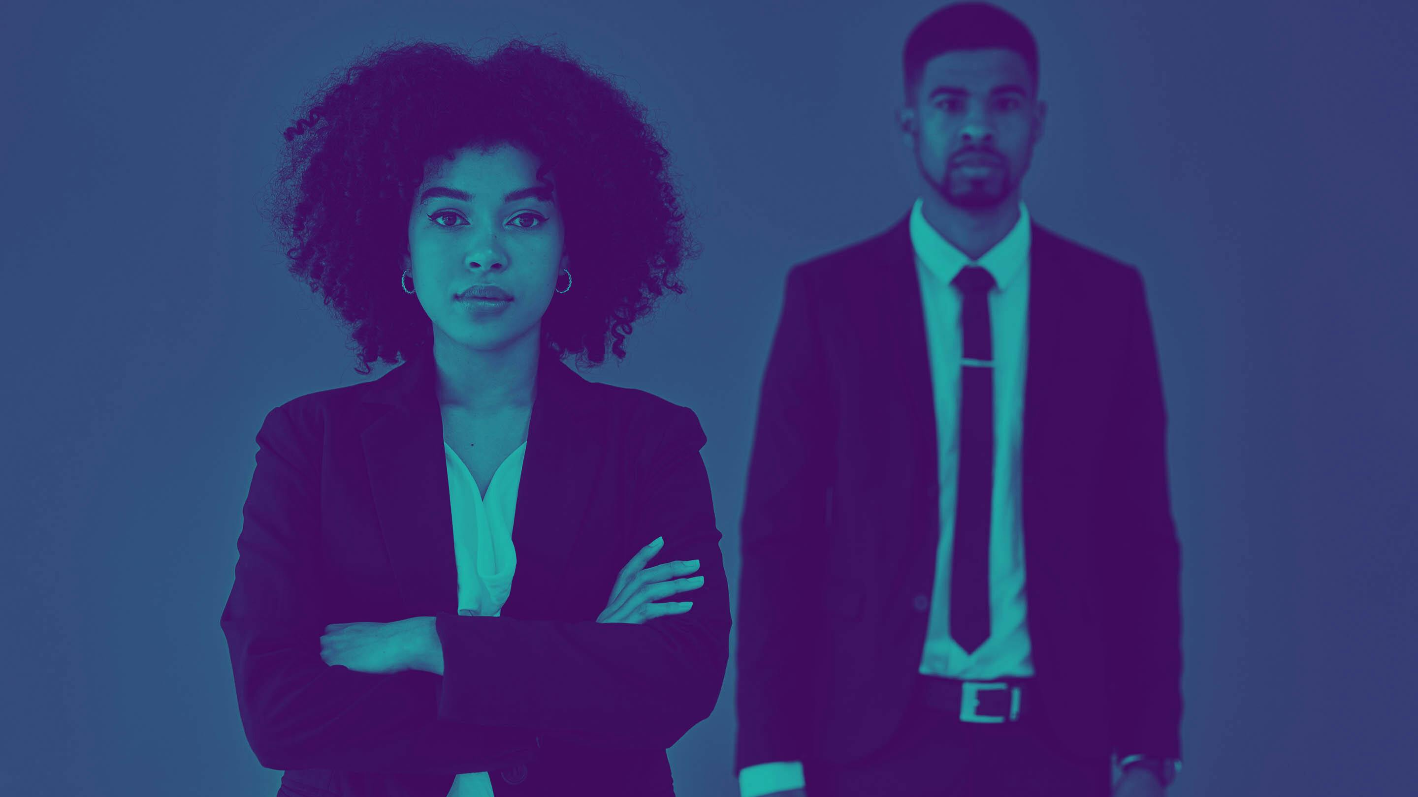 Portrait of black business woman and black business man standing with arms crossed.