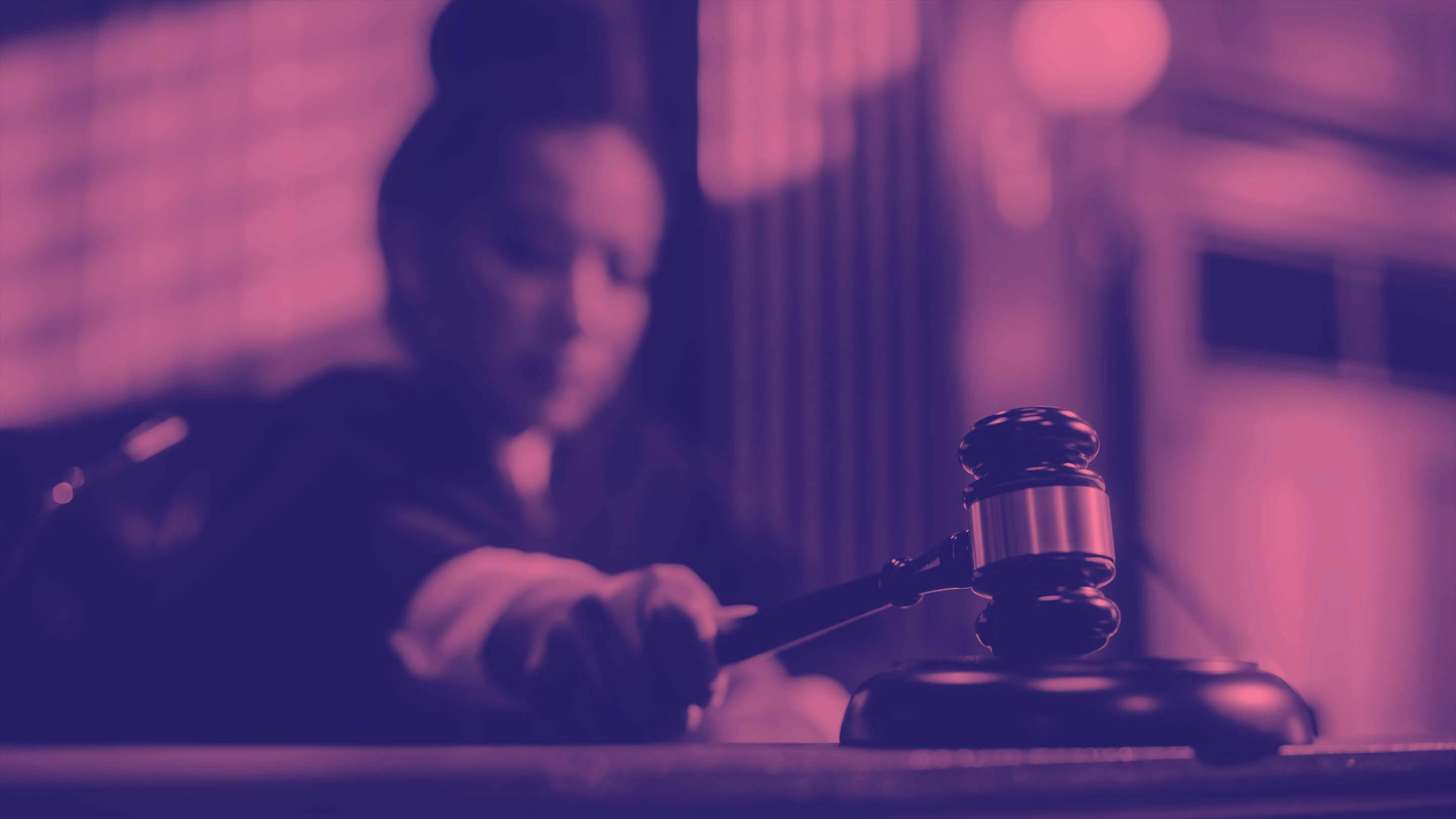 Stylized image of female judge with gavel in her hand.